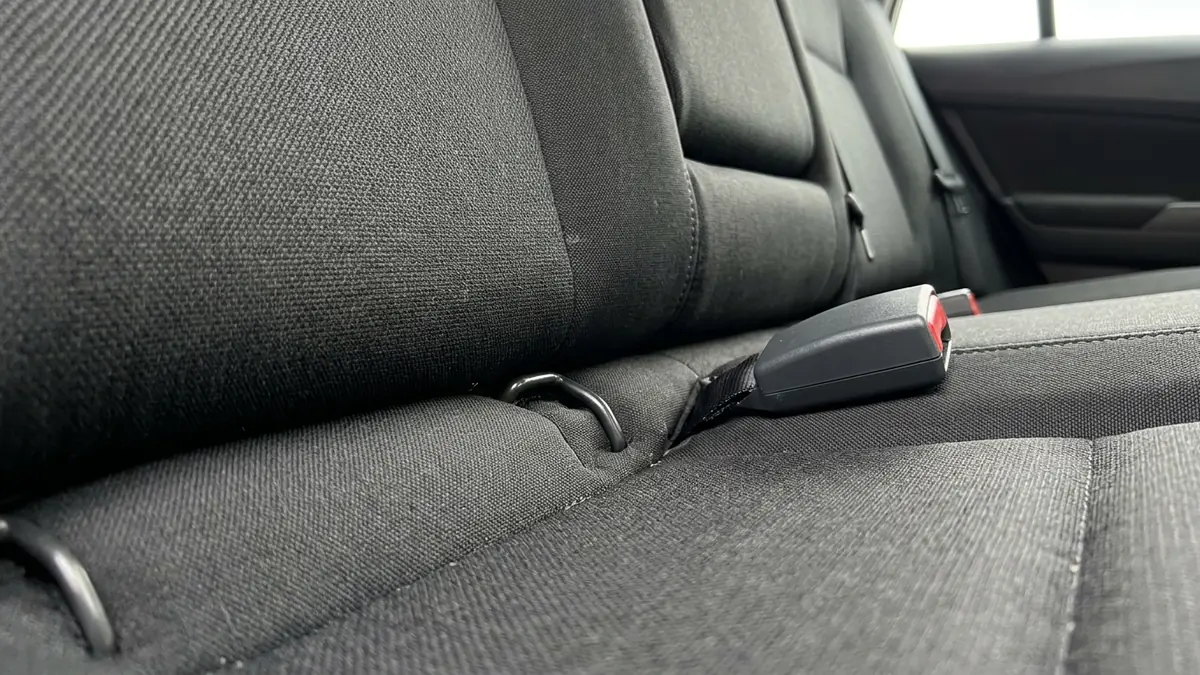 Common car seat installation mistakes: lower anchor bars and seat belt buckle on a rear seat